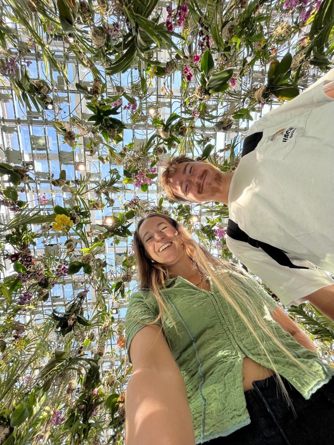 Jojo and Louis under hanging flowers