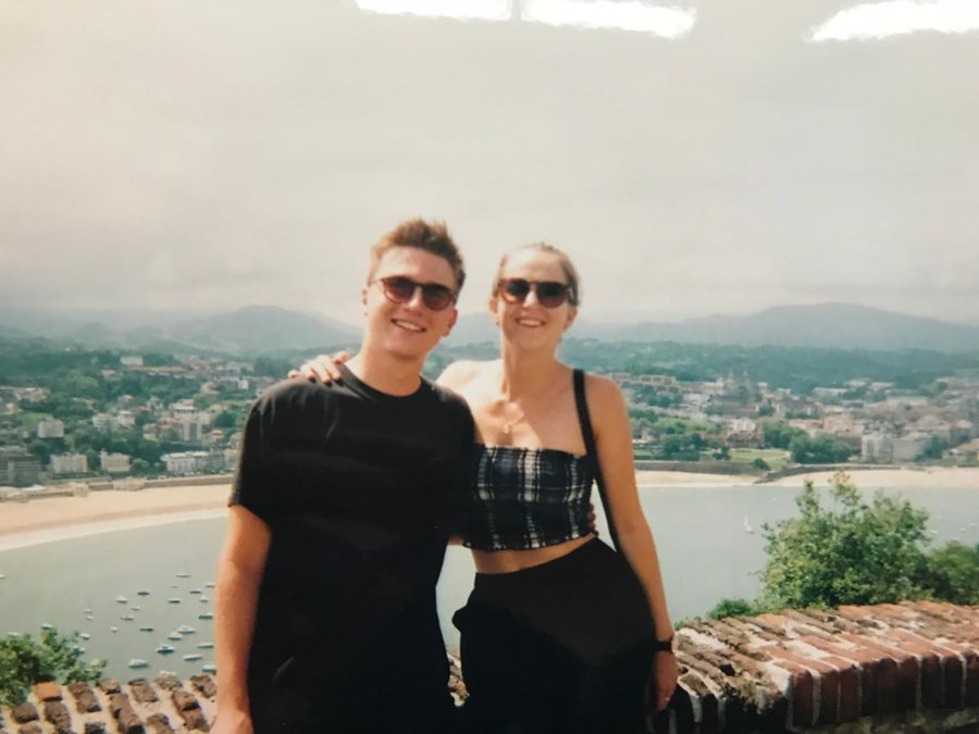 Jojo and Louis in sunglasses with a view behind them